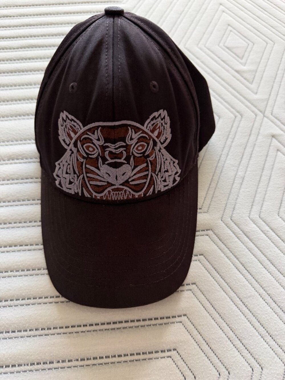 Black Kenzo cap, one size fits all. The white in the photo is from the salt wate